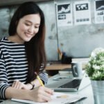 young-asian-office-woman-working-with-laptop-computer-desk-office-background-office-lifestyle-concept
